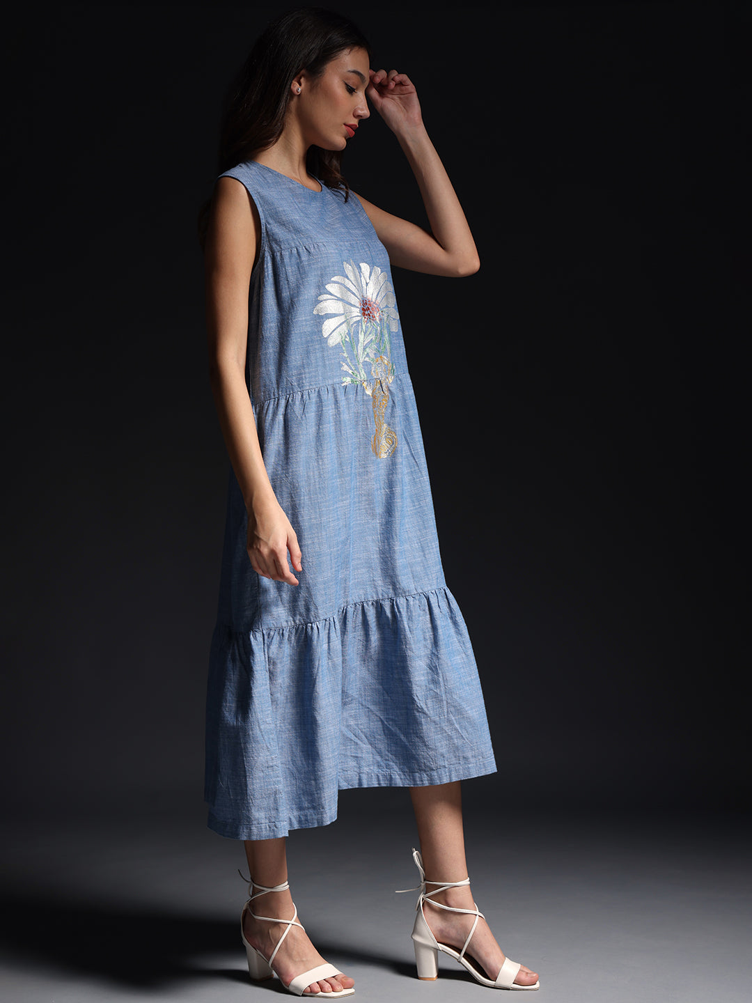 Gotamoda sleeveless maxi dress in blue with floral print worn by woman with white heels