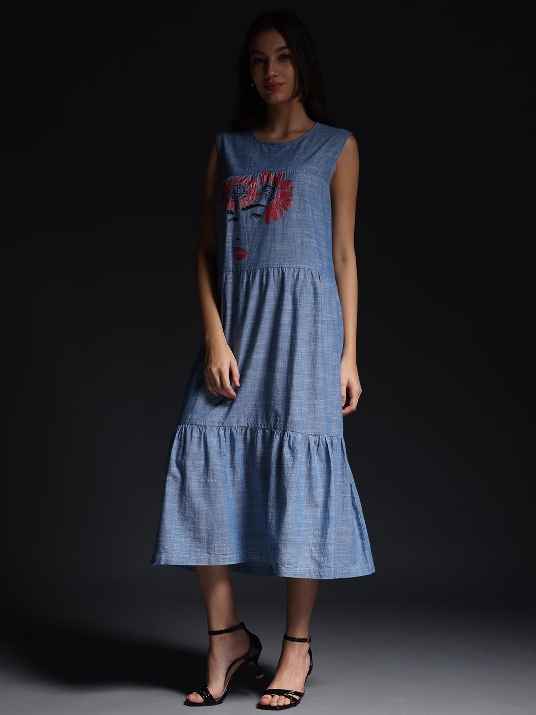 Gotamoda sleeveless maxi dress in blue with artistic face print and tiered skirt design