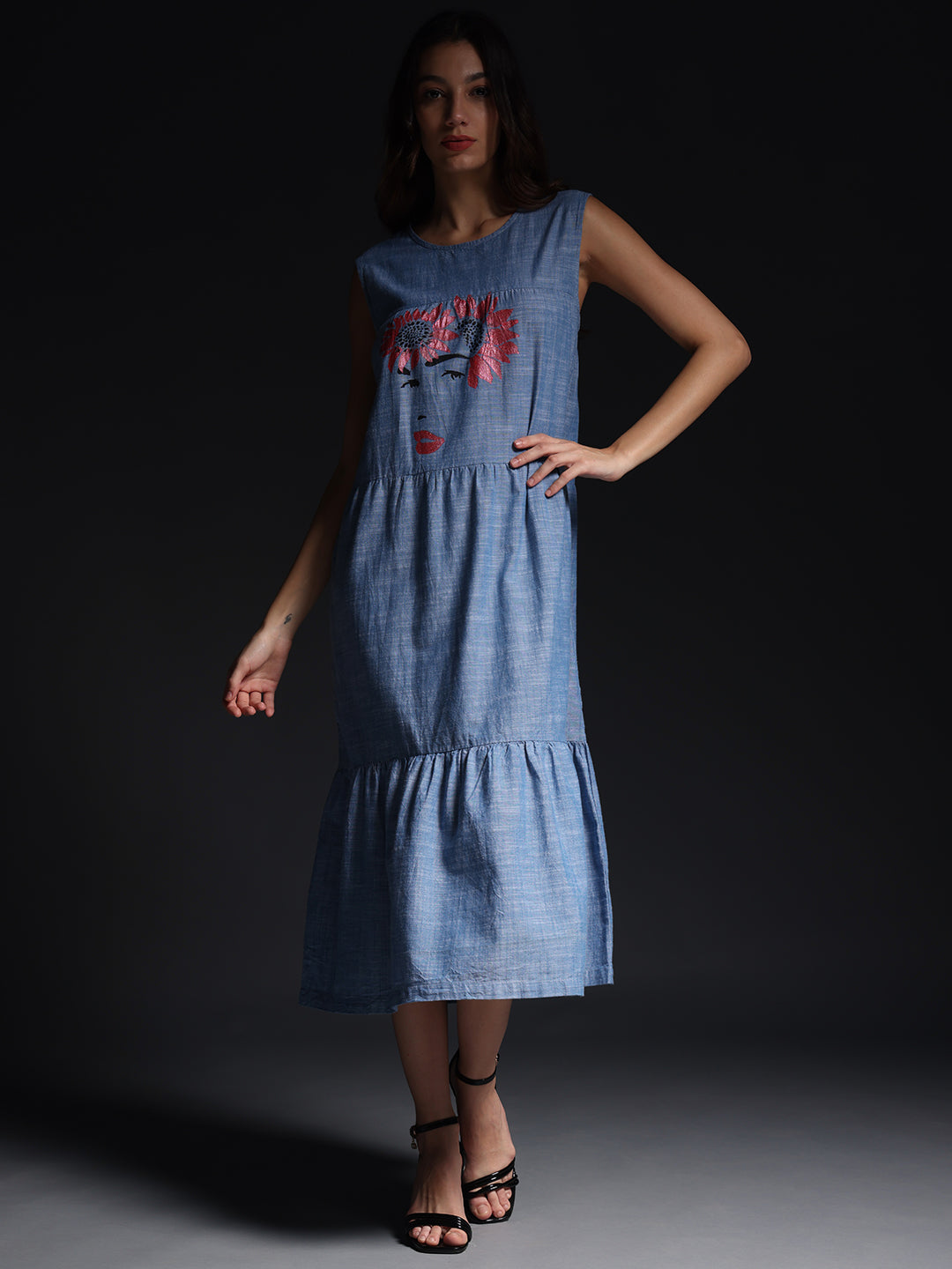 Gotamoda sleeveless maxi dress in blue with artistic face print and tiered skirt style