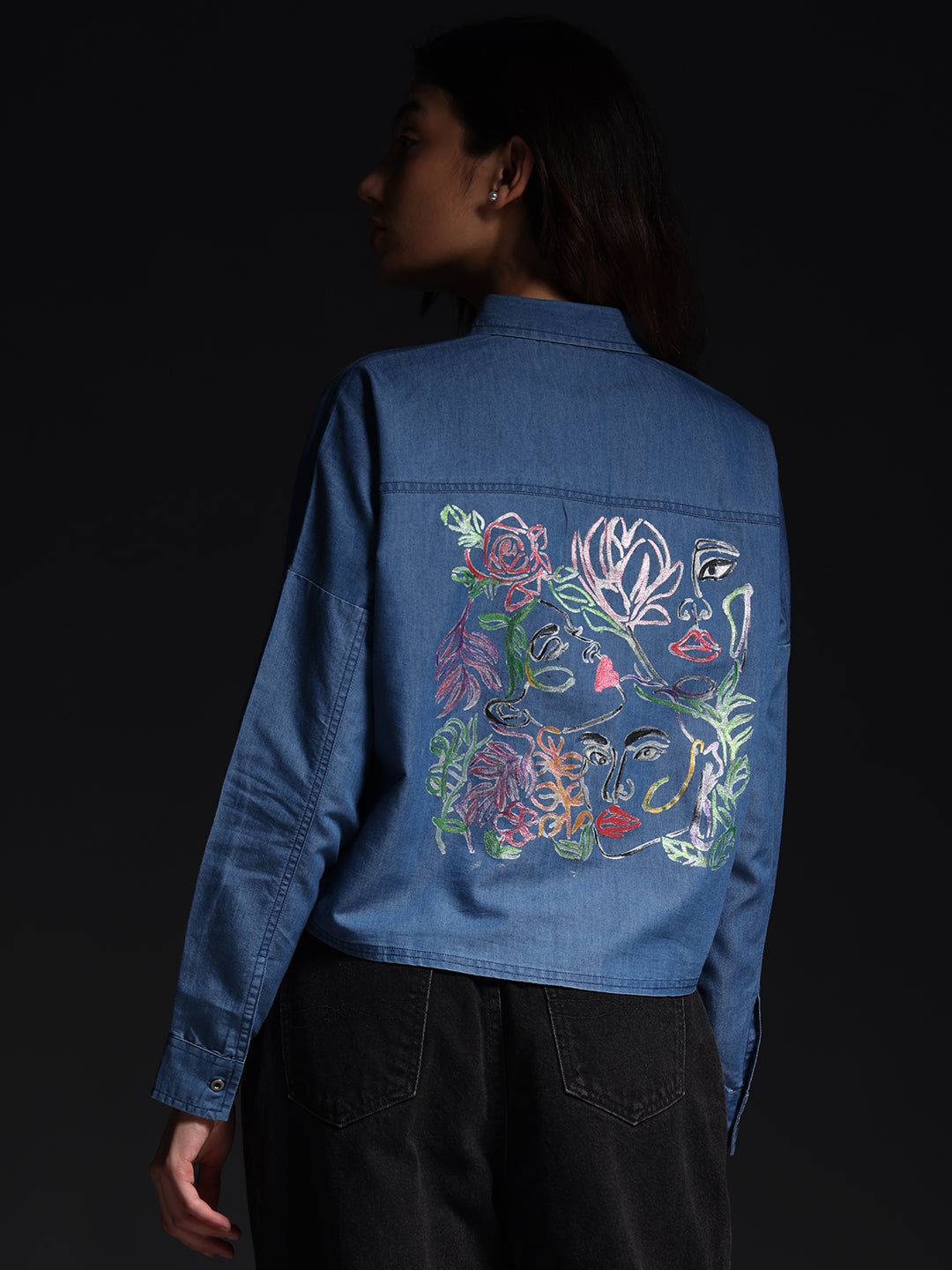 Gotamoda top jeans shirt with colorful artistic floral embroidery on the back worn by a woman