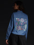 Gotamoda top jeans shirt with colorful artistic floral embroidery on the back worn by a woman